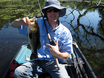 dave lengyel holding bass fish from fishing swamp