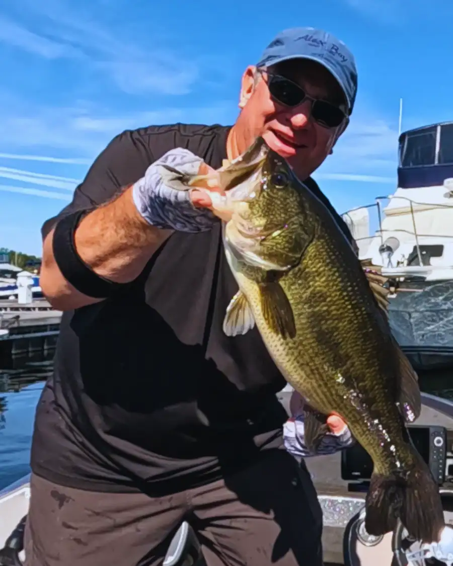 Bass fisherman hold lunker largemouth bass caught on Lake Champlain