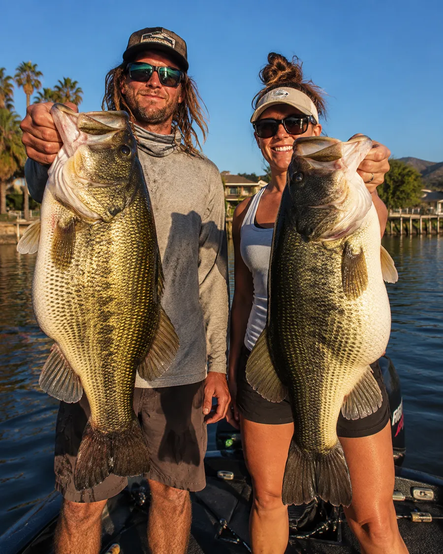 Two anglers holding trophy largemouth bass during a fishing trip on Clear Lake, California
